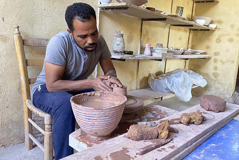 Ashraf AbdelKadr creating a piece of pottery.