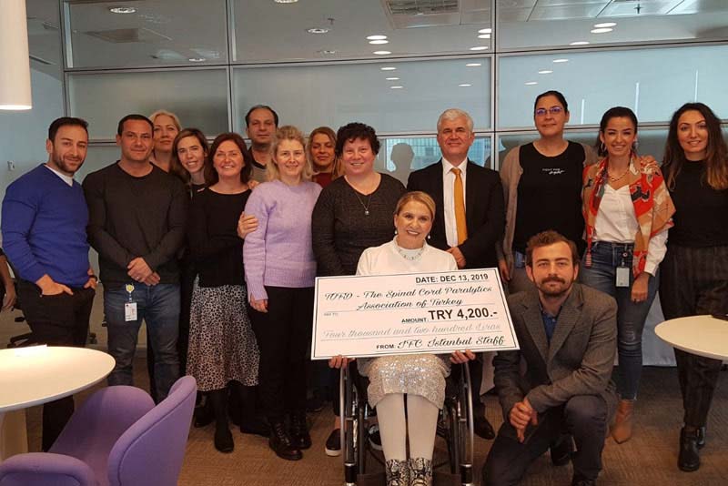 IFC Istanbul Staff in 2019 donating their 8th battery operated wheelchair to the Spinal Cord Paralytics Association of Turkey
