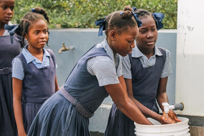 Haitian children washing their hands before lunch.