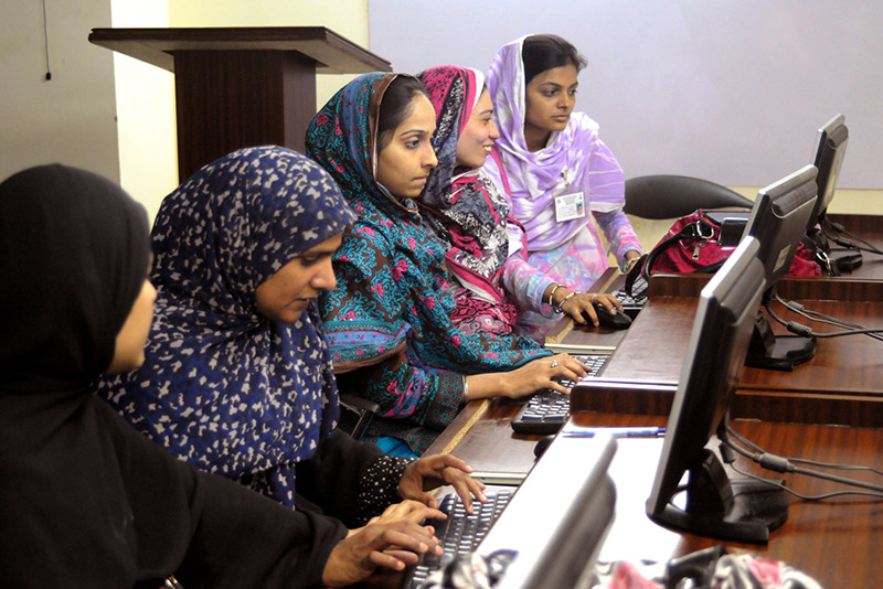 Young women learn computer skills in Pakistan, will benefit from a steady stream of electricity during summer months.