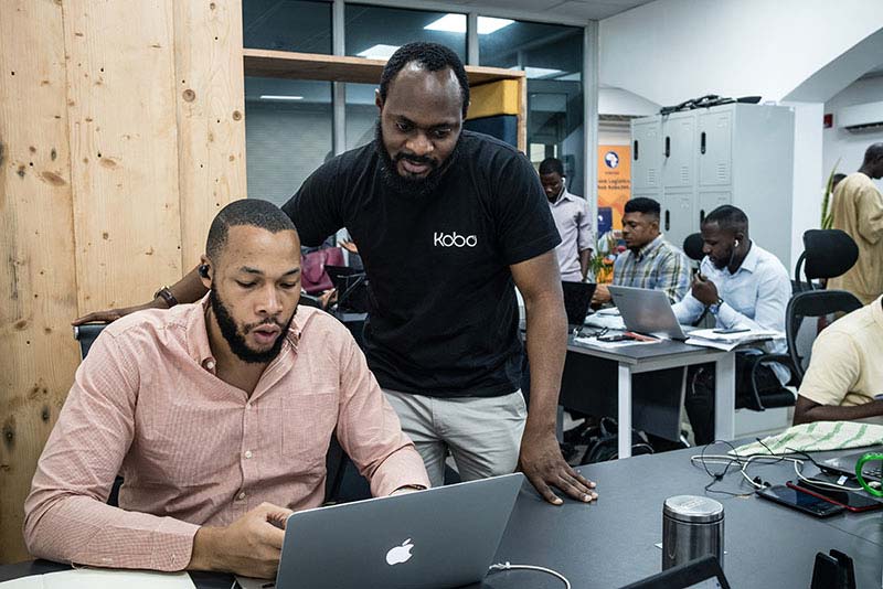 Obi Ozor, CEO of Kobo 360, supervises an employee in Lagos, Nigeria.