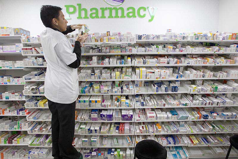 Filling prescriptions for customers at a pharmacy in Nairobi, Kenya.
