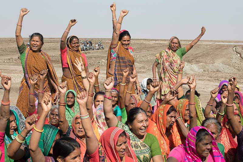 Salt pan workers celebrated during the closing remarks of an IFC event and site visit in Little Rann Off Kutch, India.