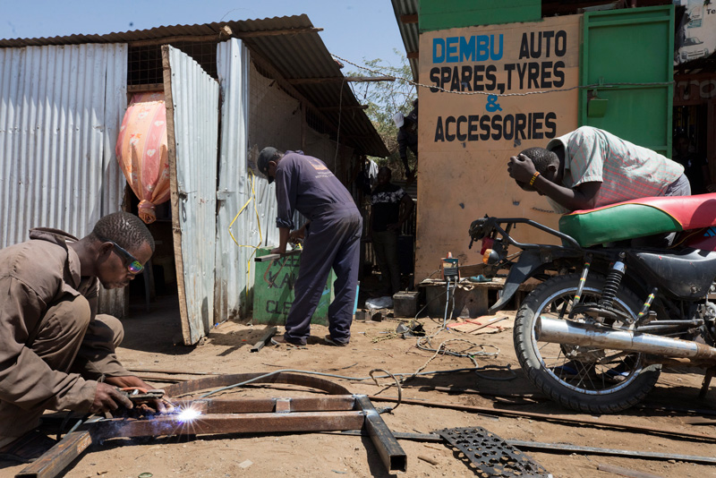 Mberwa Abdallah Ali (left), a refugee from the Democratic Republic of Congo, started his own business in Kakuma in 2017.