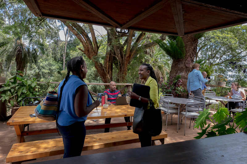 Entrepreneurs network in the outside patio of Ikigai, a co-working space for small business, in Nairobi, Kenya
