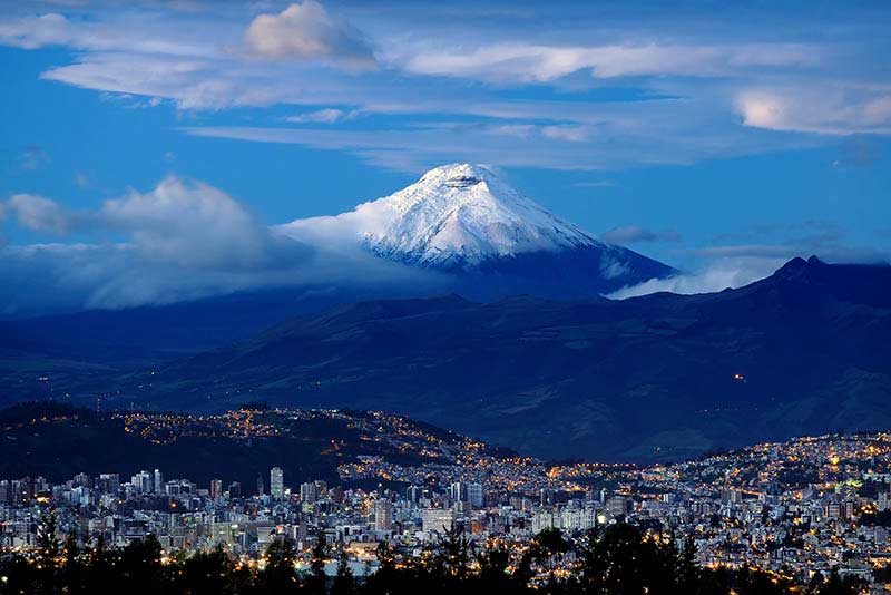 Sunrise in Quito City and the Cotopaxi volcano.